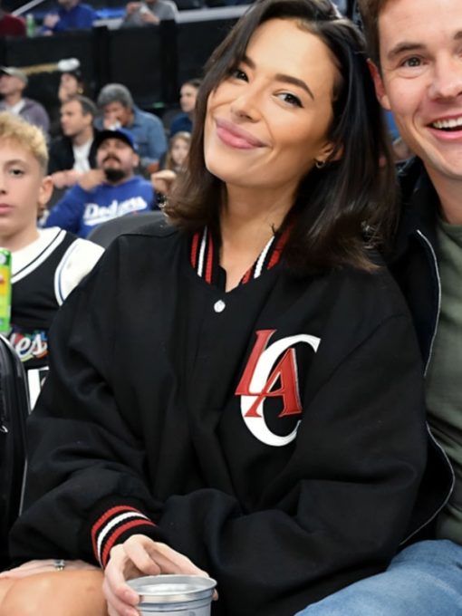 Person wearing a black jacket with 'LA' logo at a sports event