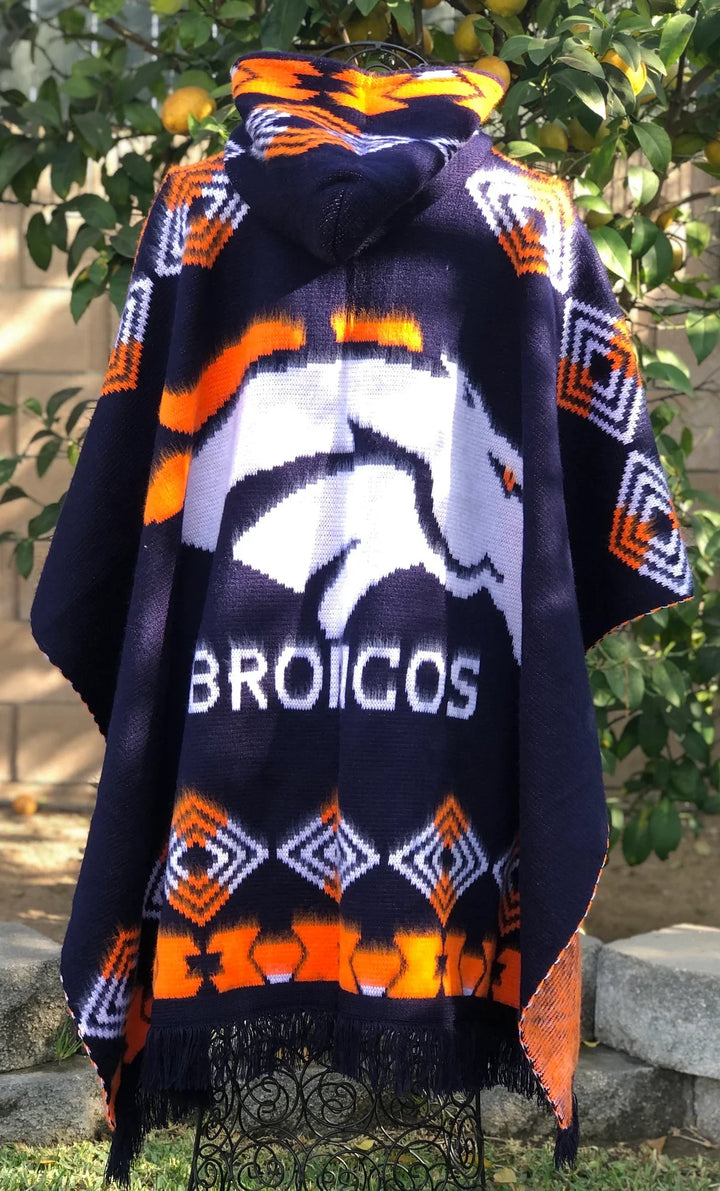 Navy blue poncho with Denver Broncos logo and orange patterns, worn by a person outdoors.