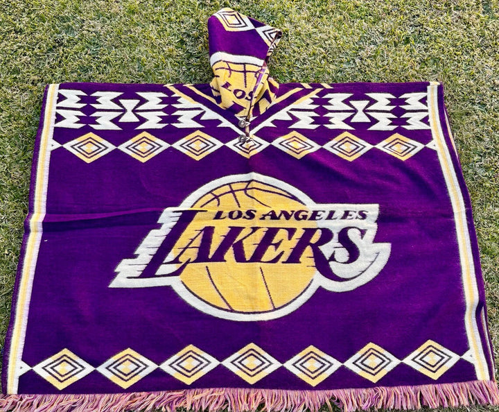 Los Angeles Lakers blanket with logo and fringes on a grassy background