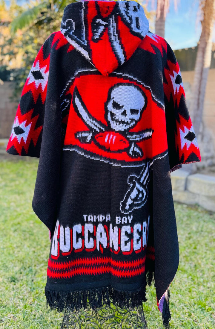 Poncho with Tampa Bay Buccaneers logo and skull design in a grassy area