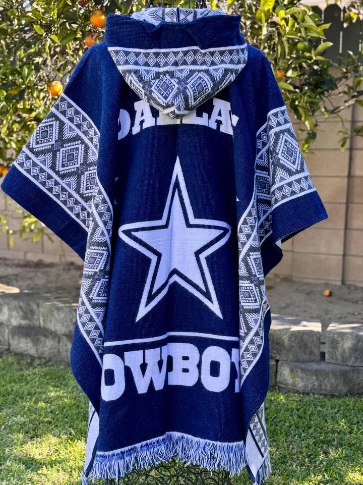 Navy blue poncho with white star and 'Cowboys' text, worn outdoors.