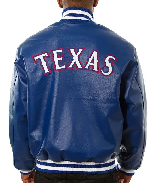 Blue varsity jacket with 'TEXAS' on the back, worn by a person.